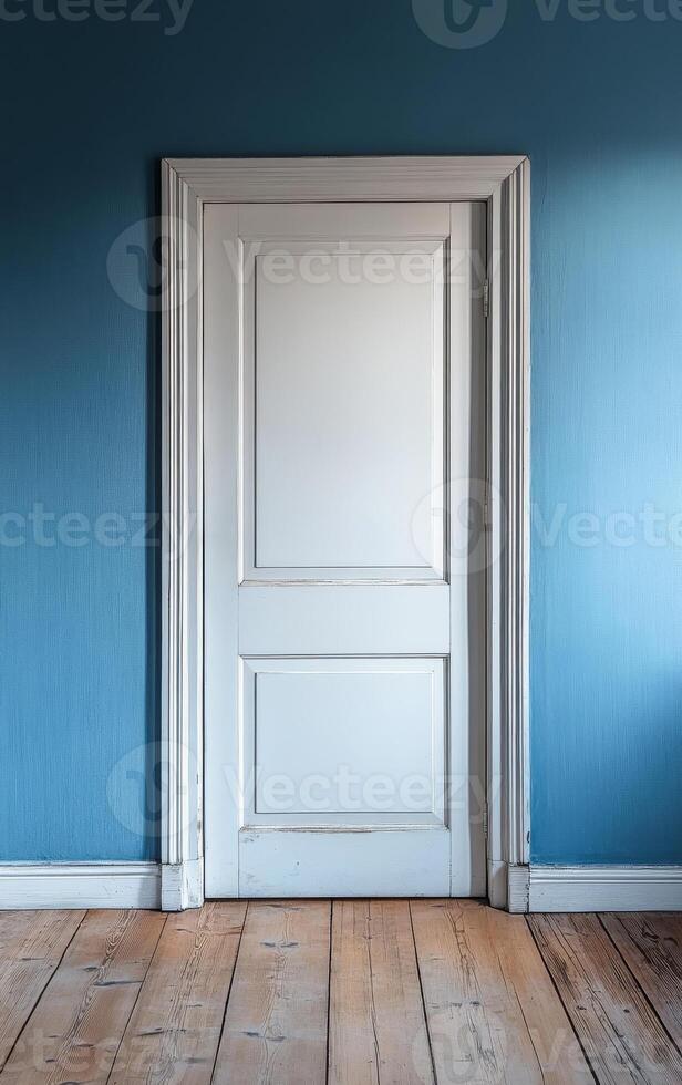 A white door with a blue wall in the background. The door is open and the room is empty photo