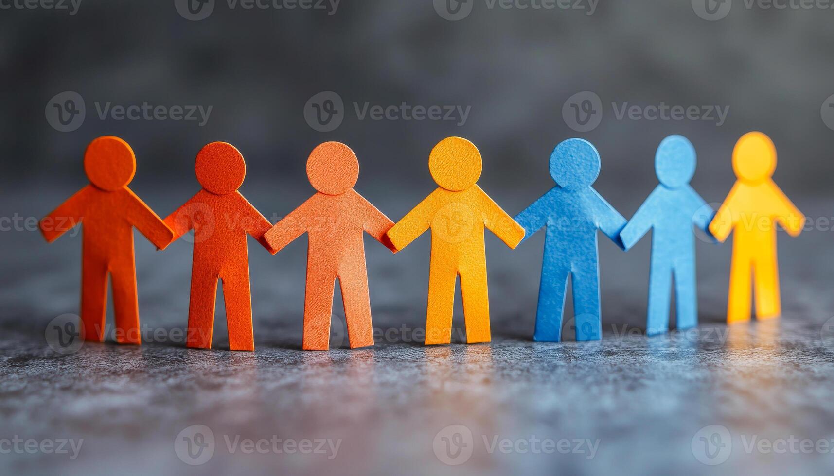 Colorful paper figures holding hands in unity. Paper figures in bright colors join hands to symbolize friendship and collaboration in an abstract setting. photo