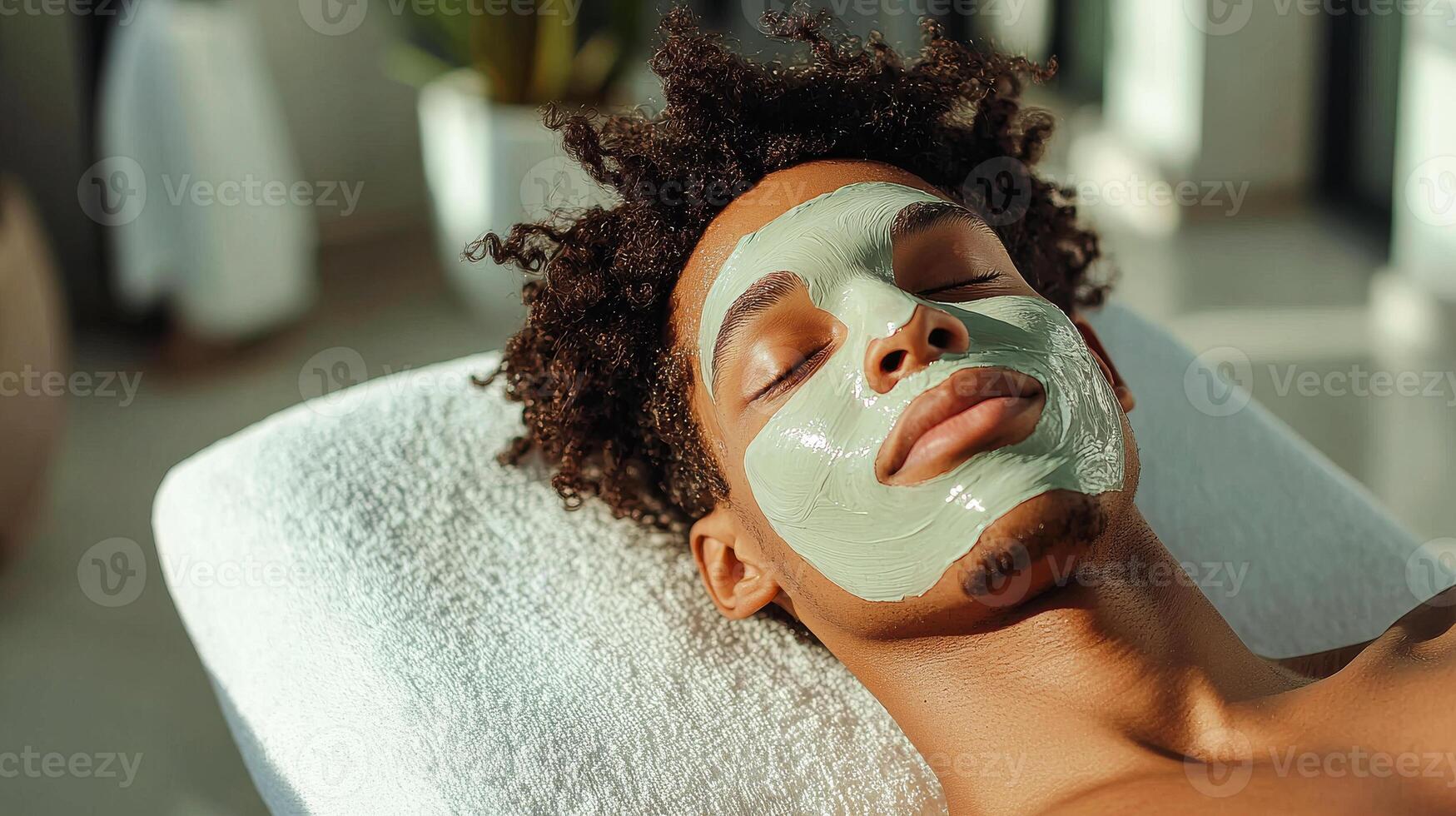 Relaxation and self-care during a facial treatment. A person enjoys a soothing facial treatment with a green mask, immersed in relaxation at a serene spa setting. photo