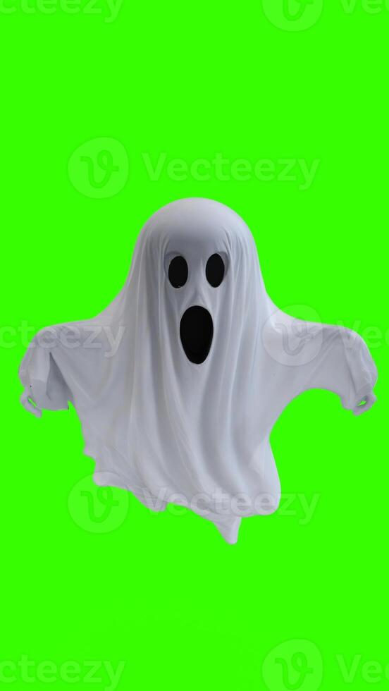 ghost in a white sheet with green background photo