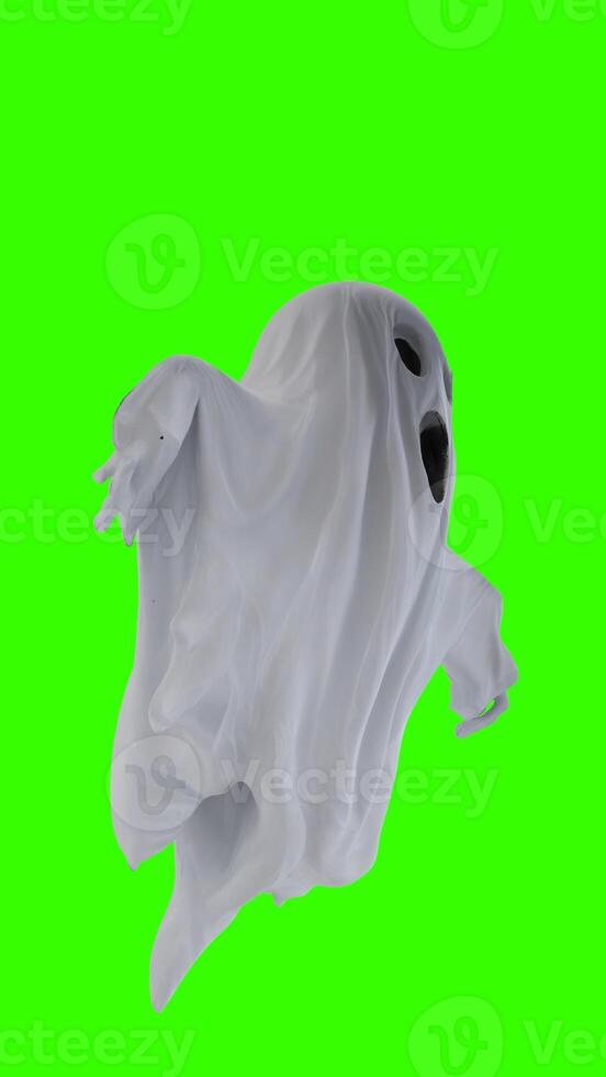 ghost in a white sheet with green background photo