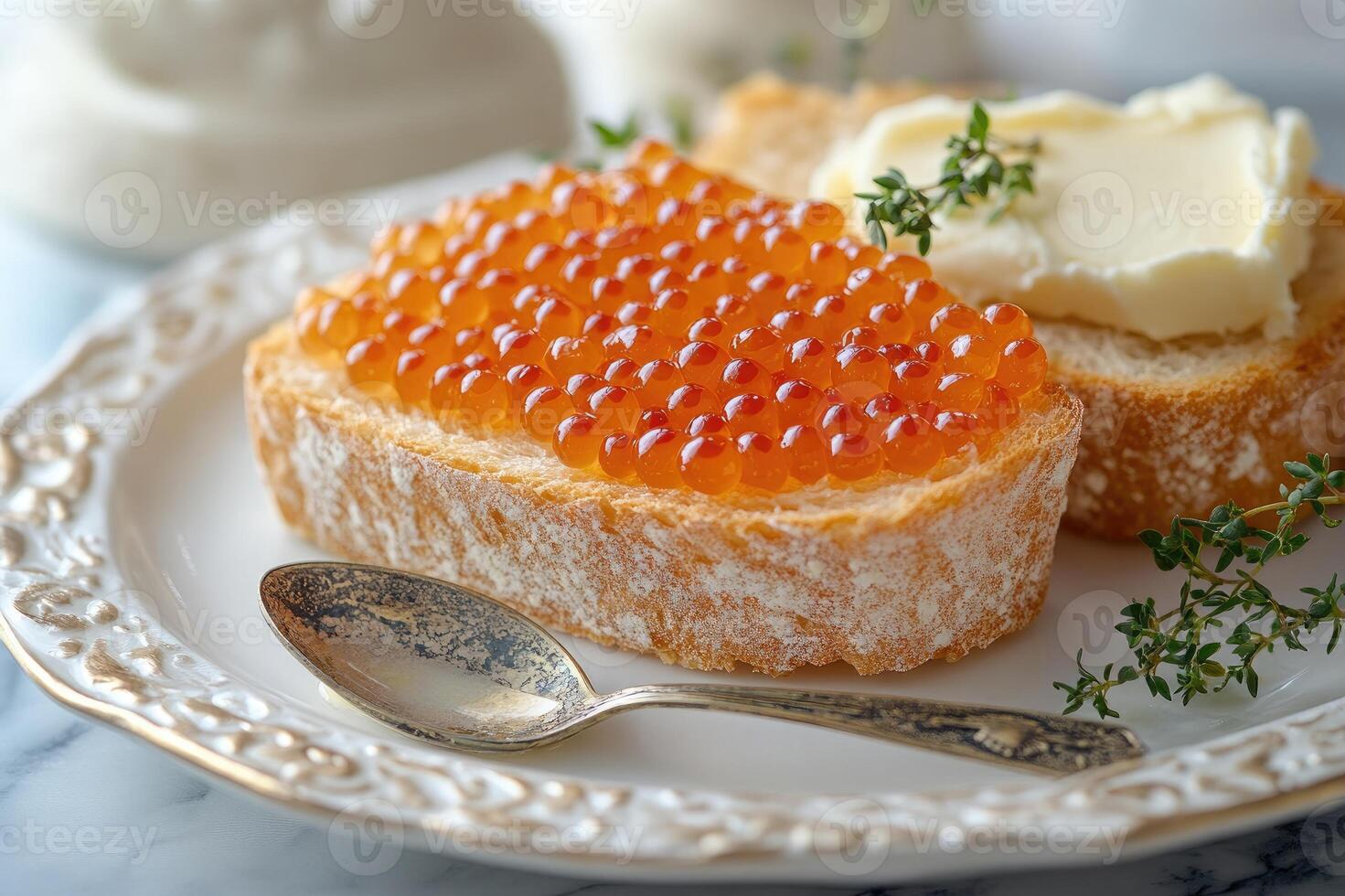 Salmon roe with bread and butter displayed on elegant table setting photo