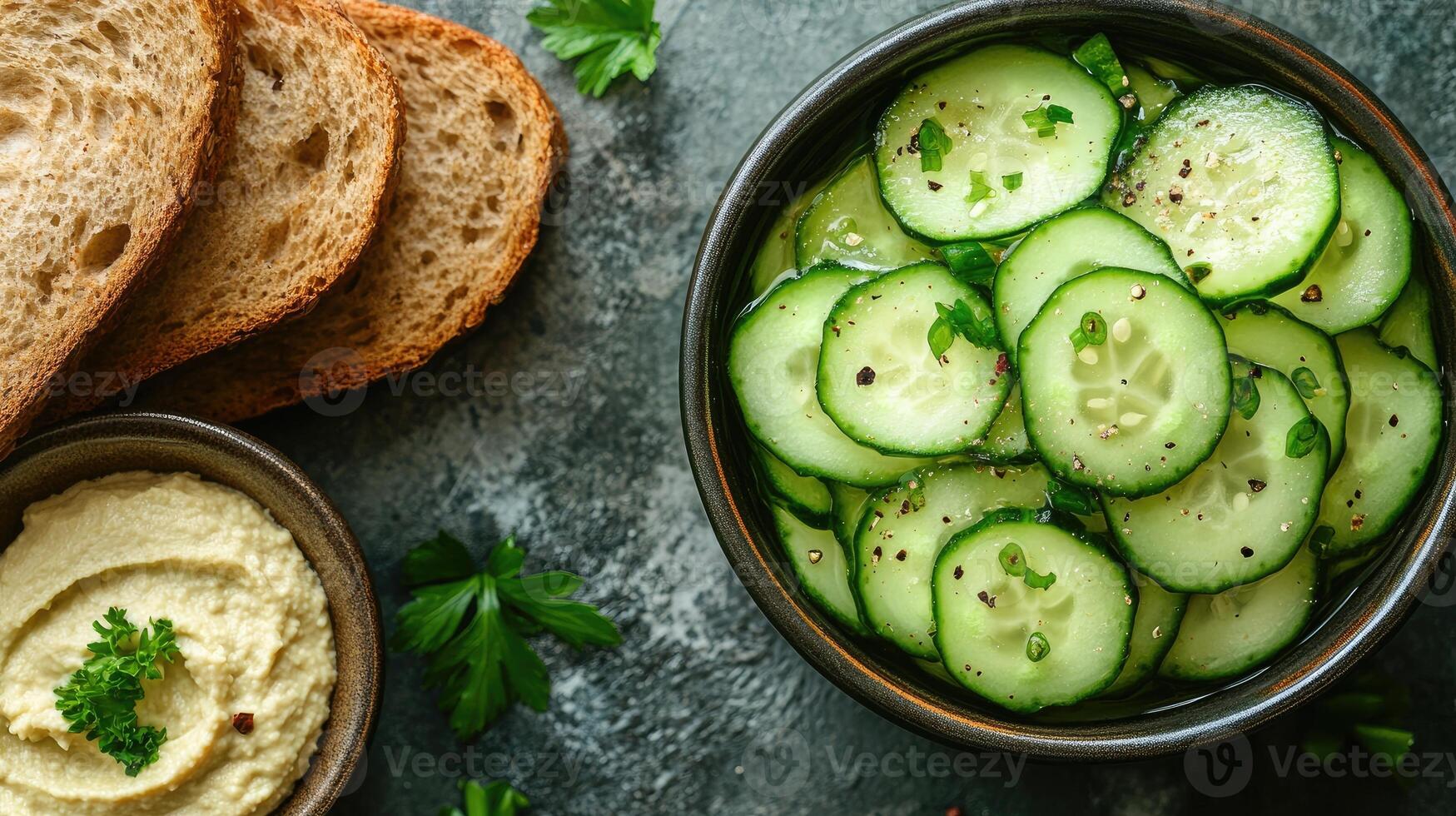 Sliced cucumber salad with parsley and black pepper seasoning in bowl photo