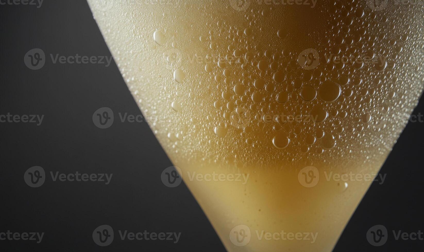 A glass of liquid with condensation on the outside photo