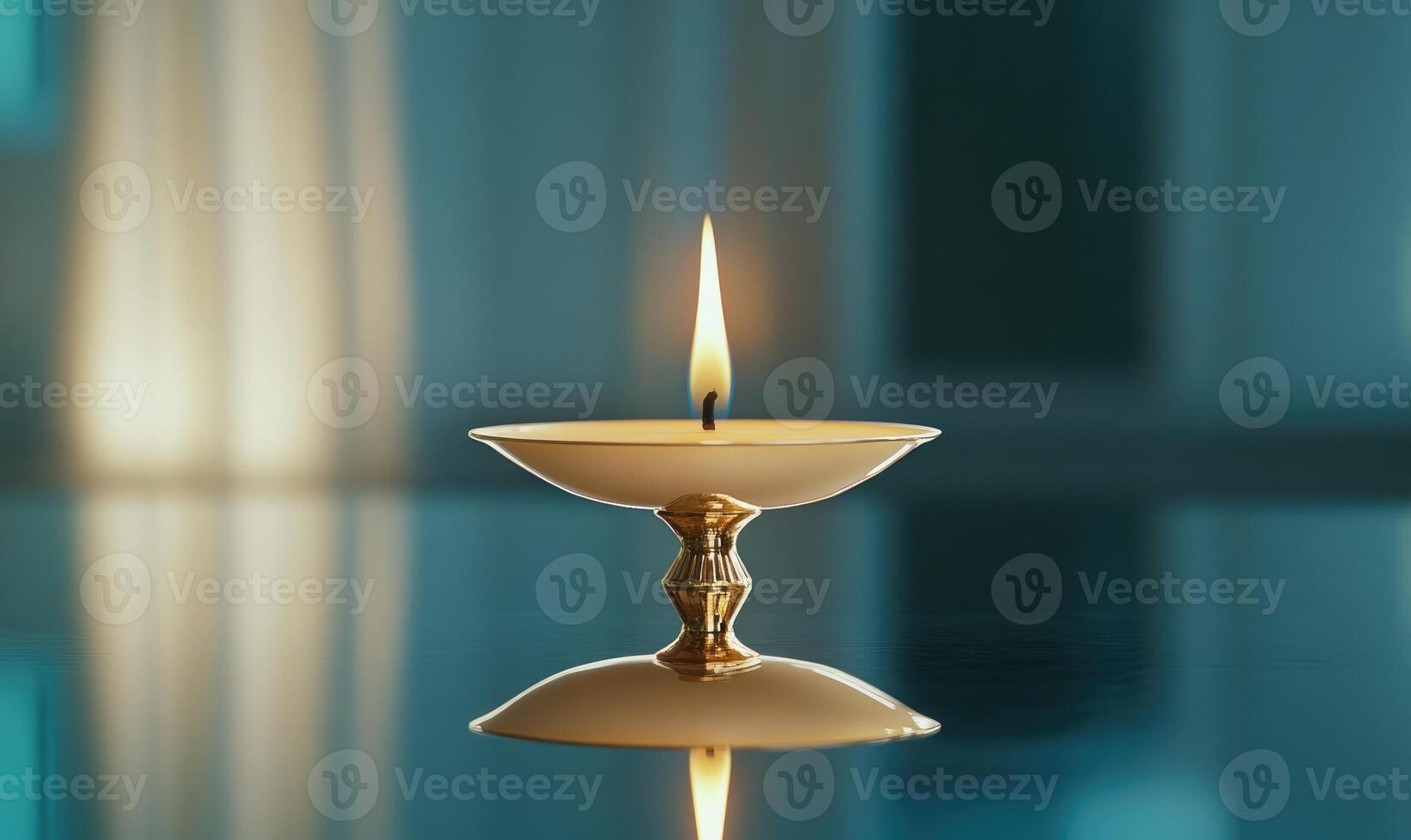 A candle is lit in a gold bowl photo