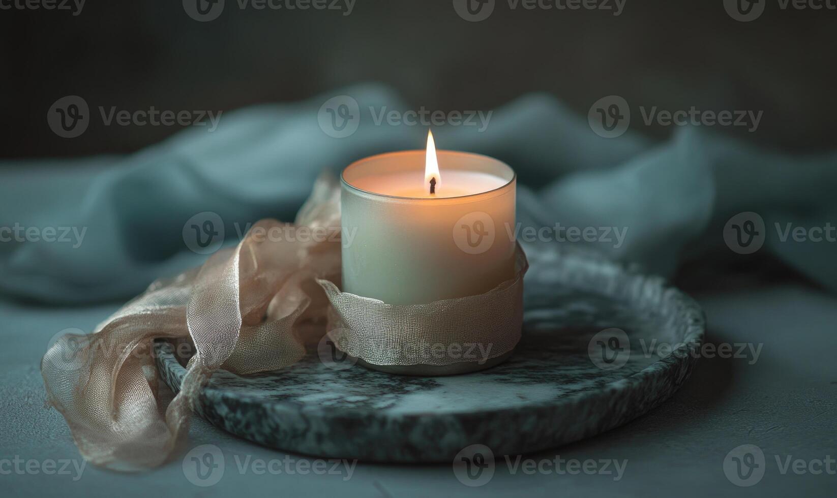 A candle is lit on a table photo