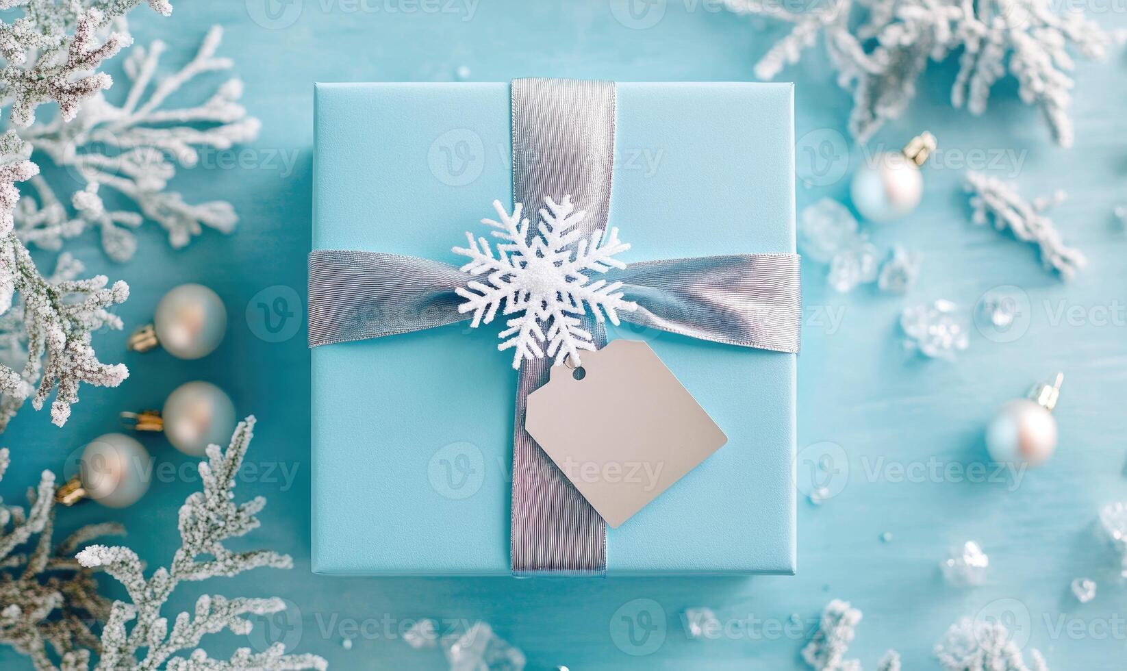A blue box with a silver ribbon and a snowflake on it photo