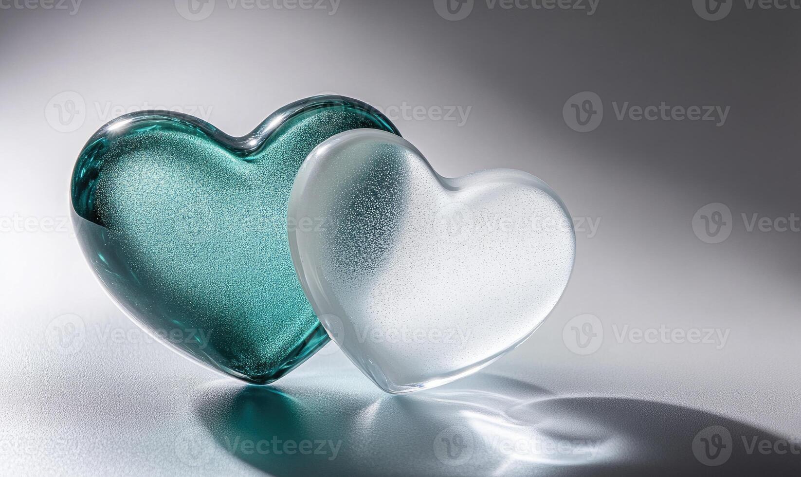 Two hearts made of glass are on a table photo