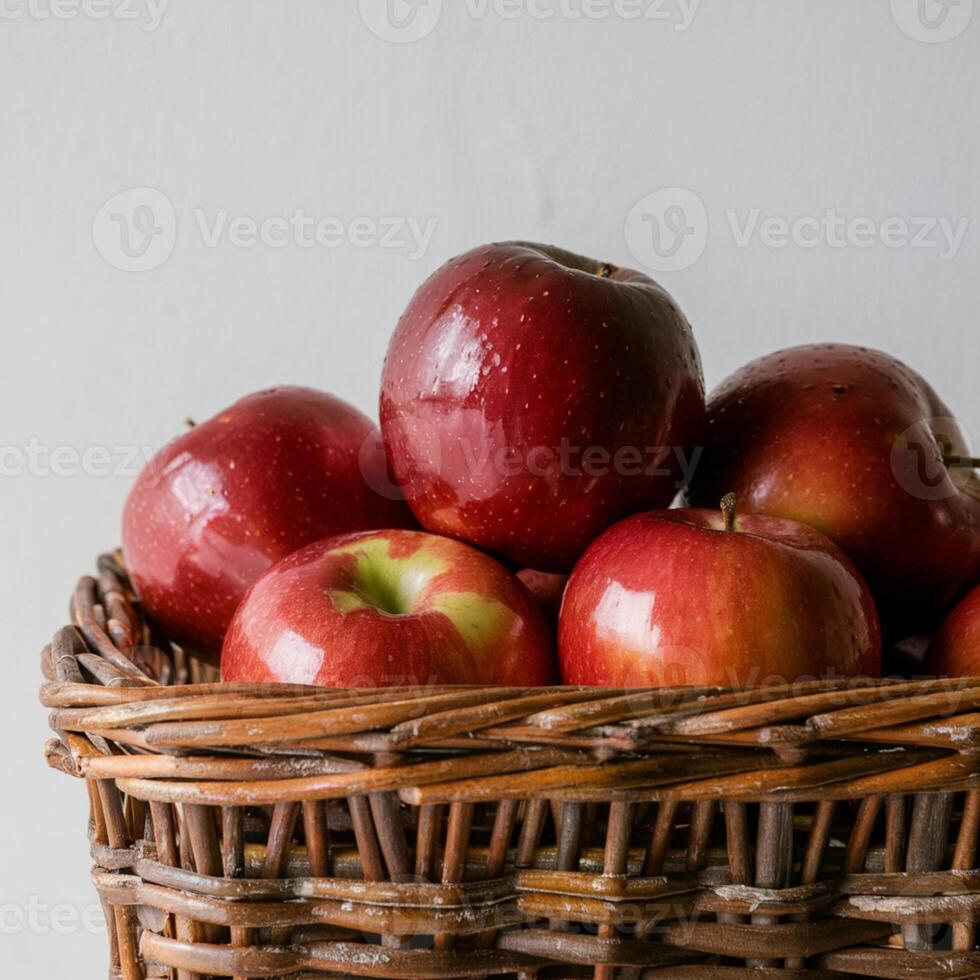 Wicker basket filled with glossy red apples, contrasting against plain white background For Social Media Post Size photo