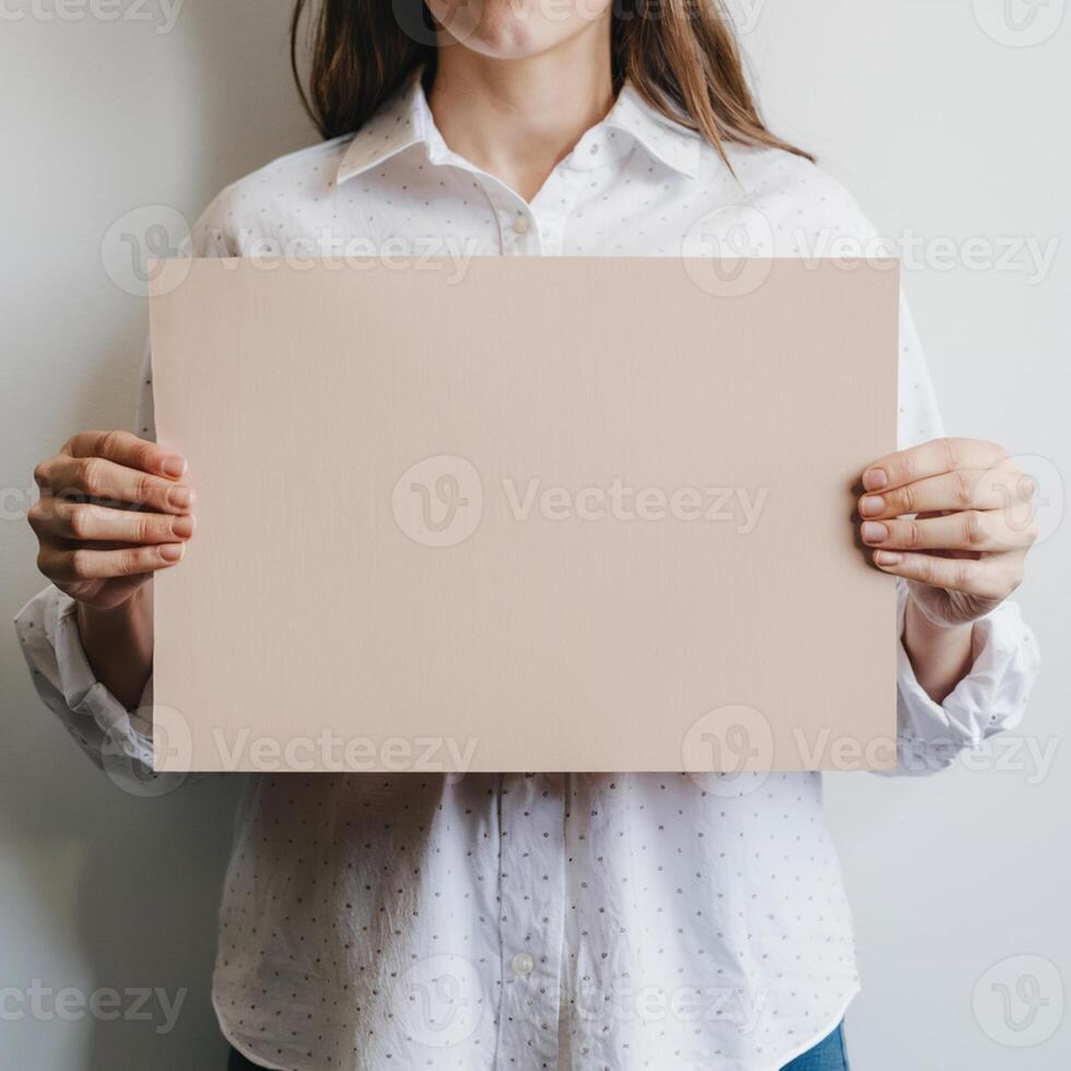 Woman holds blank placard, white shirt patterned, highlighted against plain background For Social Media Post Size photo