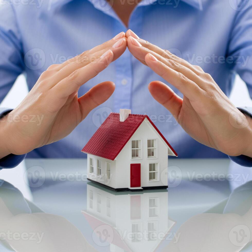 Hands protectively arch over white model house, red roof, blurred background For Social Media Post Size photo