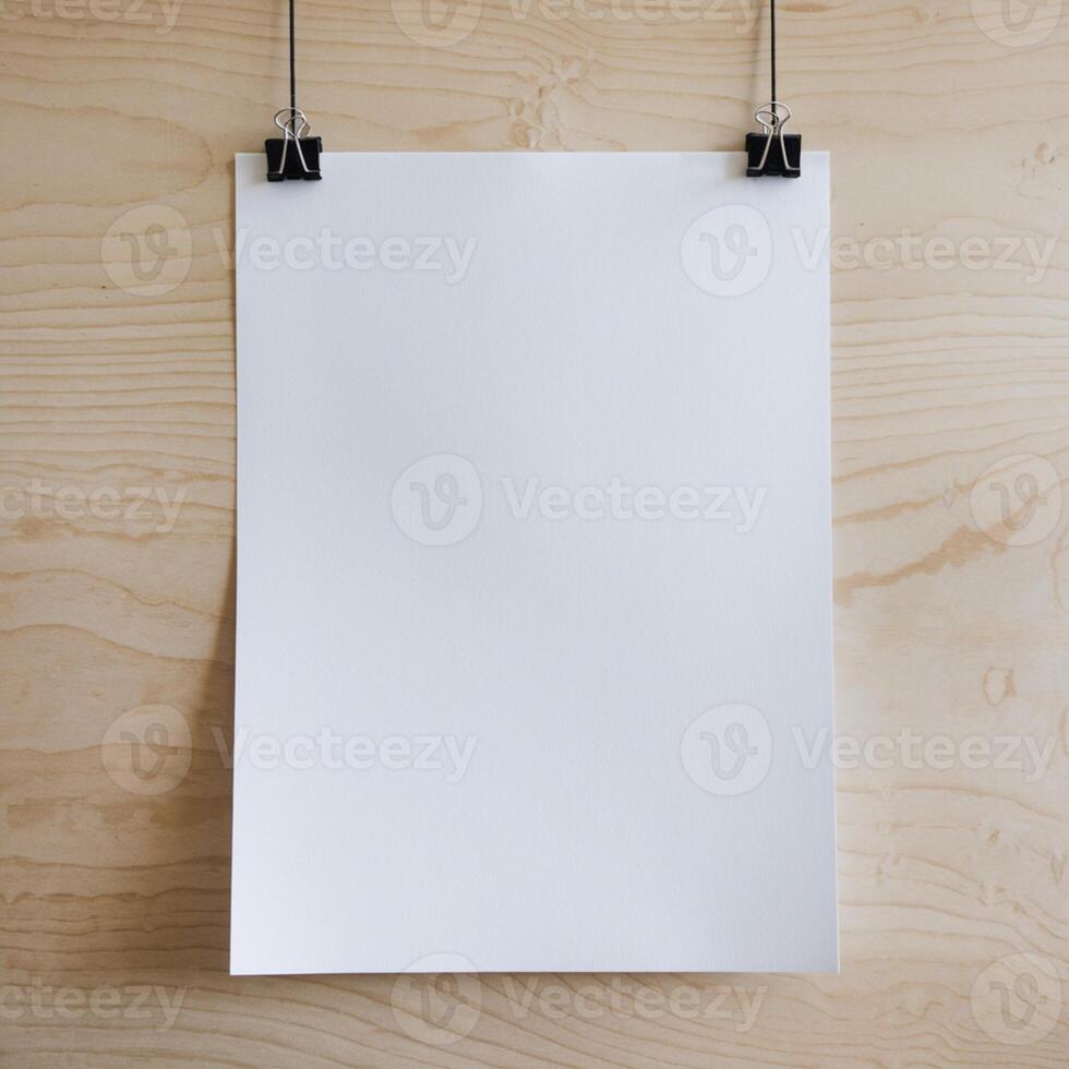White paper hangs vertically on wooden surface, secured by black binder clips For Social Media Post Size photo