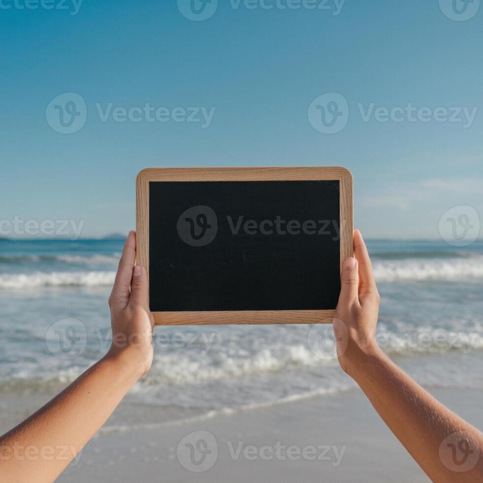 Hands present blackboard against serene beach, clear blue sky and waves For Social Media Post Size photo