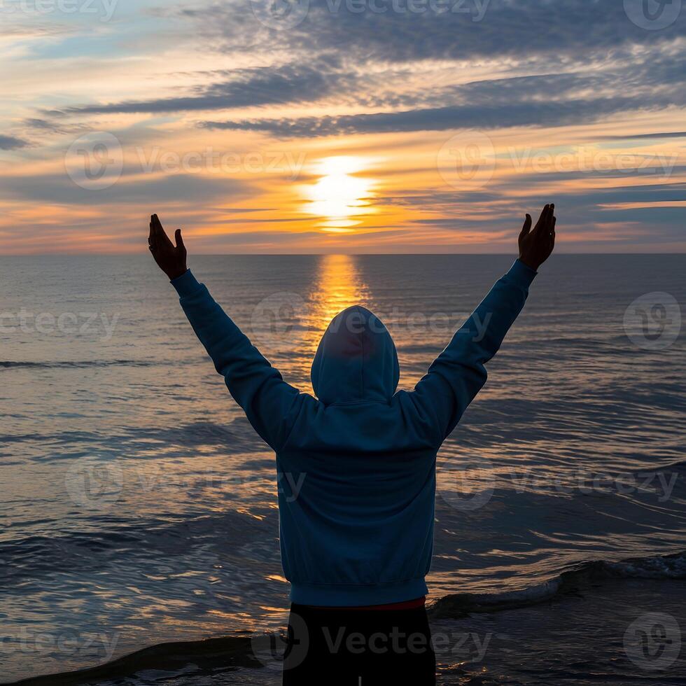 Silhouetted figure raises arms against sunset, conveying freedom and triumph For Social Media Post Size photo