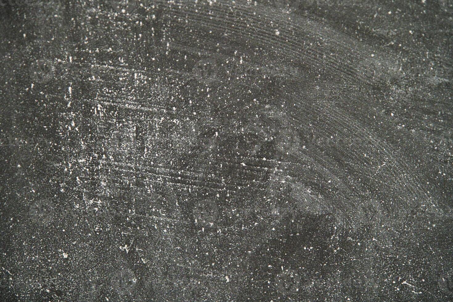 Chalkboard surface with scratches and dust in a learning environment photo