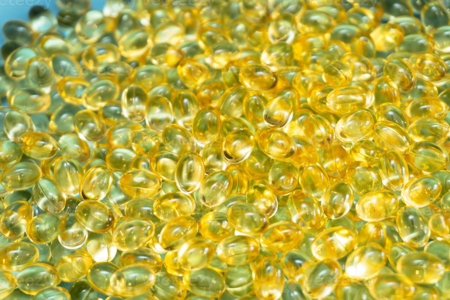 Colorful gelatin capsules displayed on a blue surface in close-up view photo