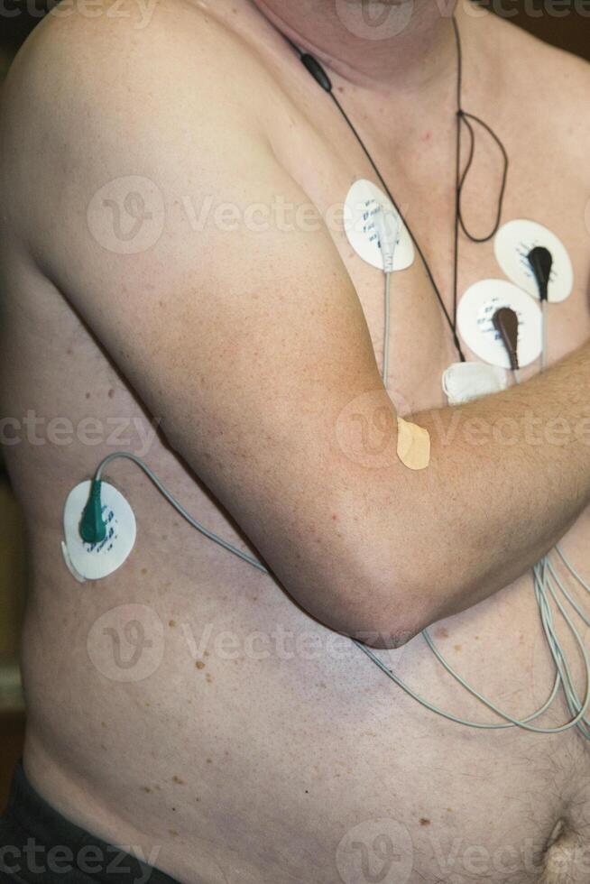 Patient undergoing electrocardiogram testing in a medical facility photo