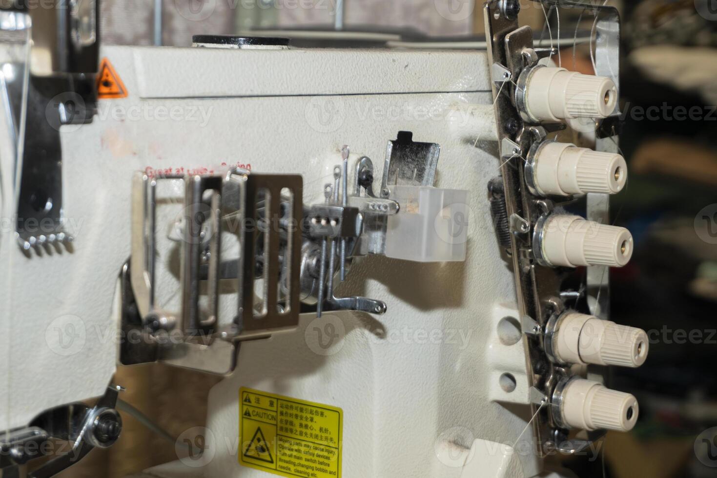 Sewing machine in operation at a textile workshop during daylight photo