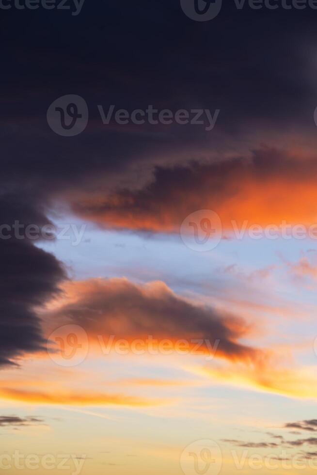Vibrant sunset clouds display colorful hues over a peaceful sky photo