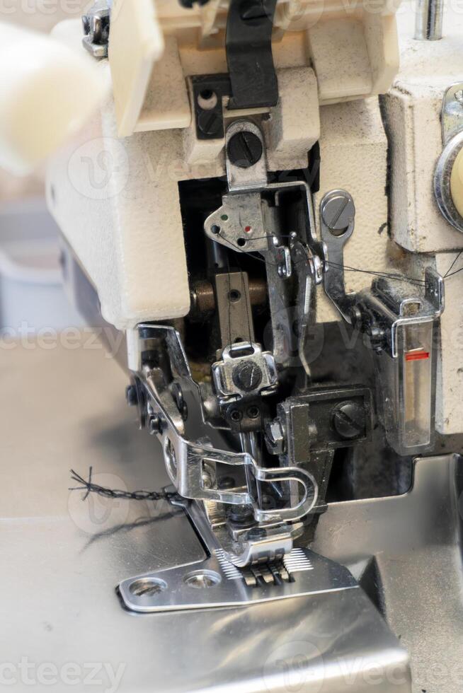 Detailed view of a sewing machine with intricate threading mechanism photo