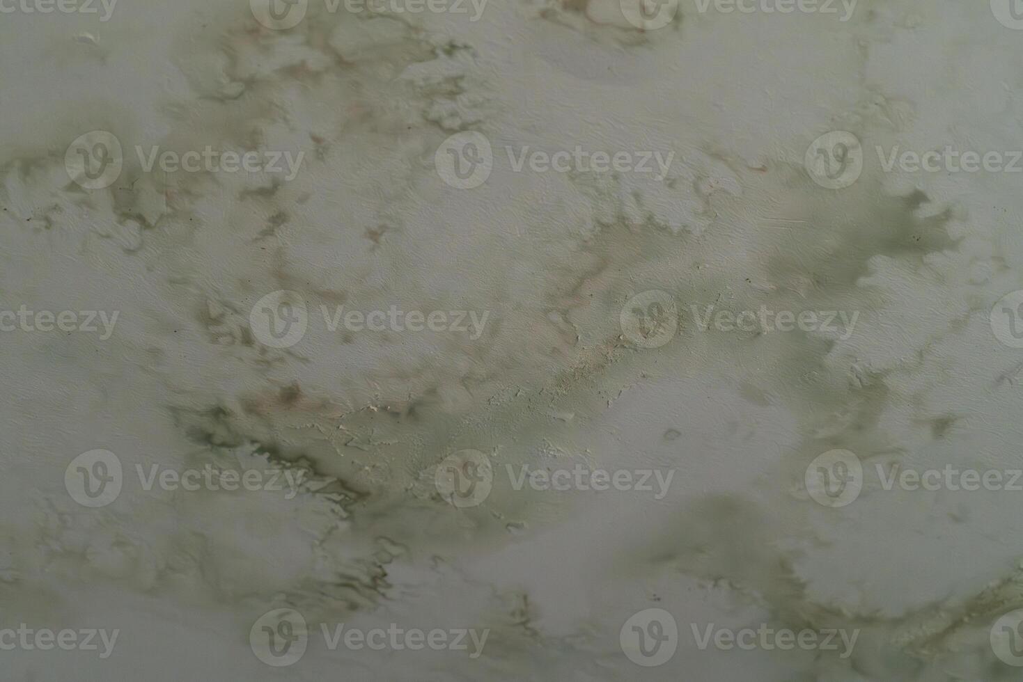Texture of peeling paint on a ceiling shows age and neglect photo