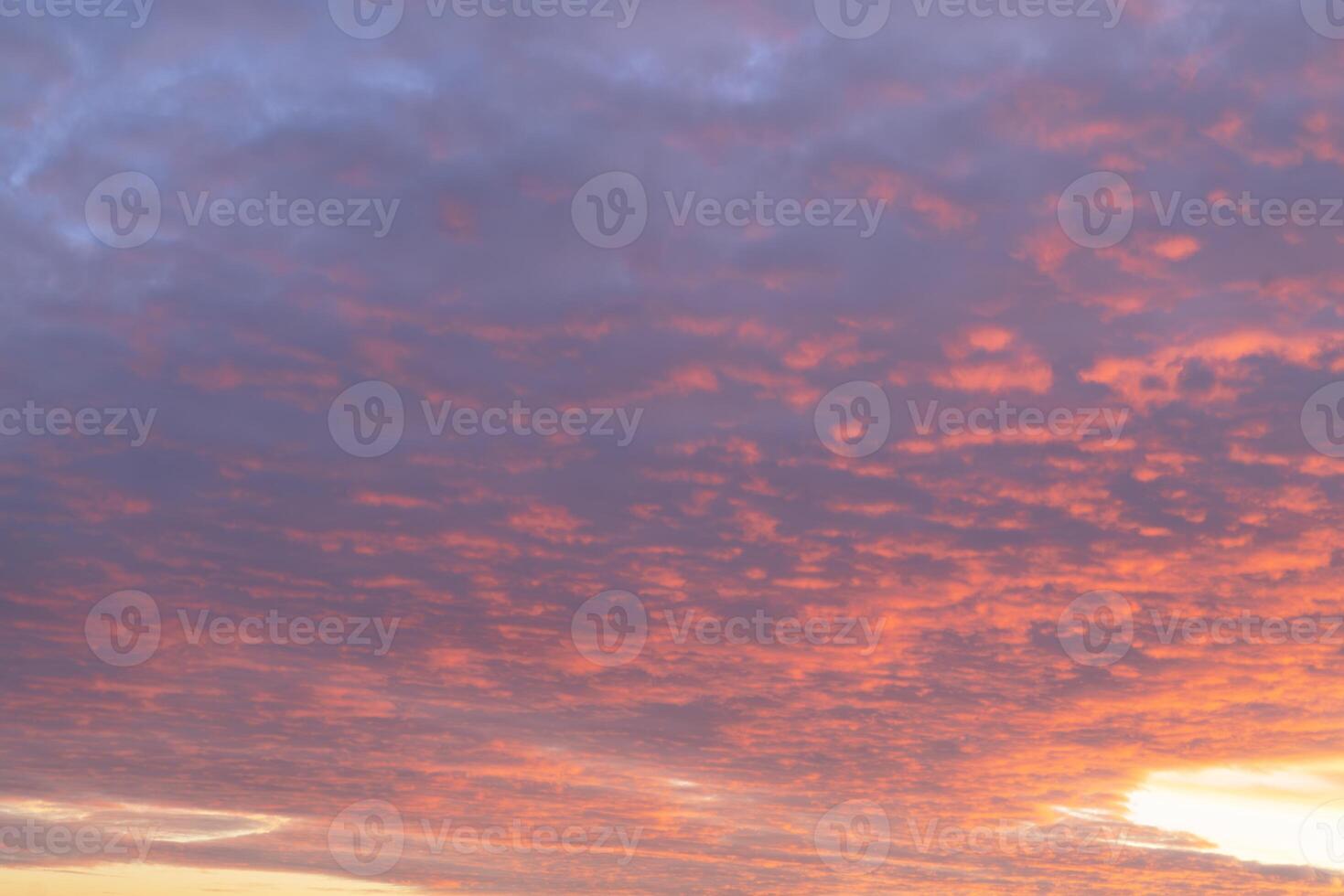 Colorful sunset with vibrant clouds over a tranquil landscape photo