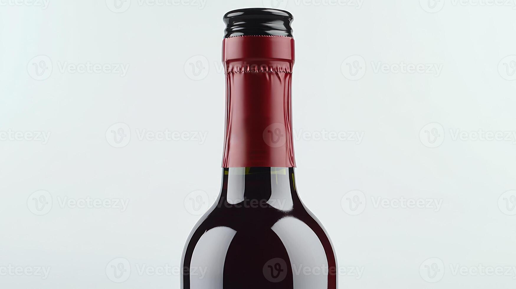 A captivating wine bottle showcases its dark glass and crimson foil in a stylish setting photo