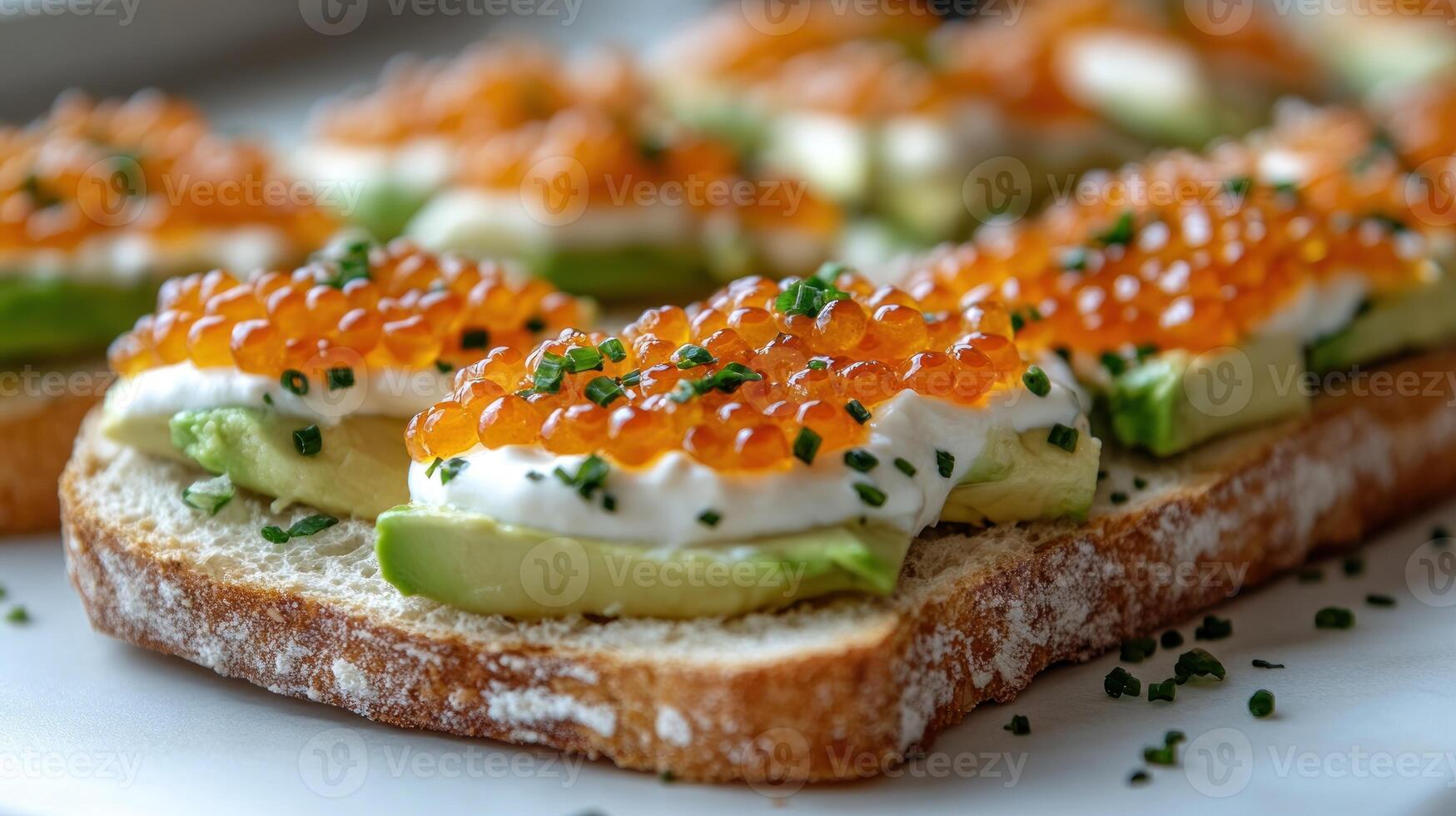 An open-faced sandwich features fresh avocado and vibrant fish roe, inviting indulgence photo
