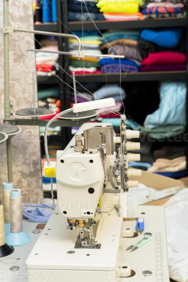 Sewing machine setup in a colorful fabric workshop photo