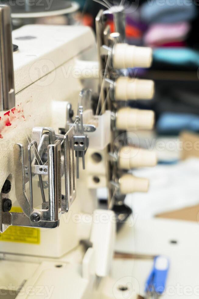 Sewing machine in action at a textile workshop during the day photo