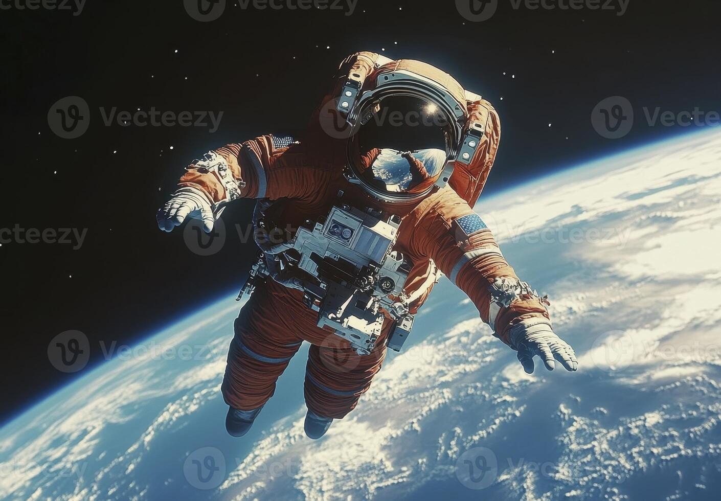 An astronaut in an orange spacesuit performs a spacewalk above Earth photo
