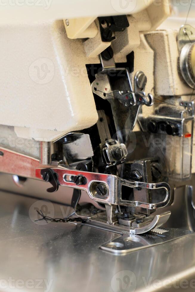 Sewing machine in action showing intricate stitching process photo