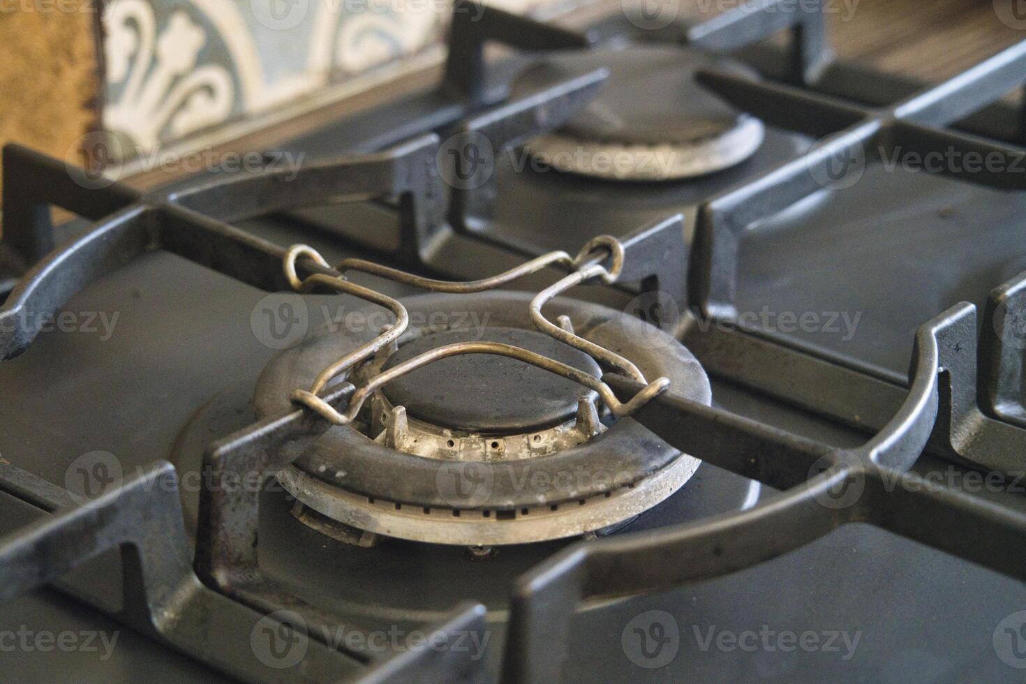 Kitchen stove with burner missing a part and showing wear photo