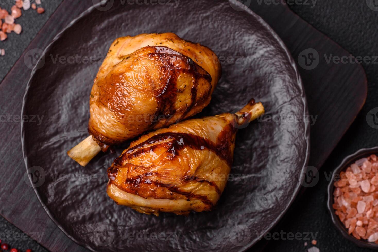 Delicious grilled chicken legs with spices and herbs in teriyaki sauce photo