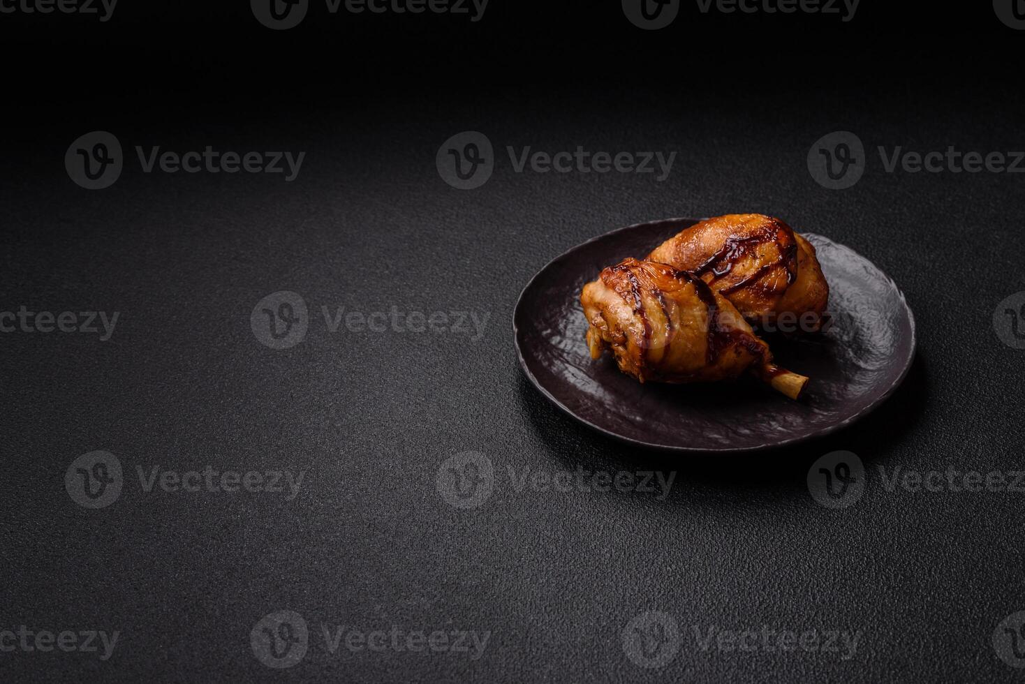 Delicious grilled chicken legs with spices and herbs in teriyaki sauce photo