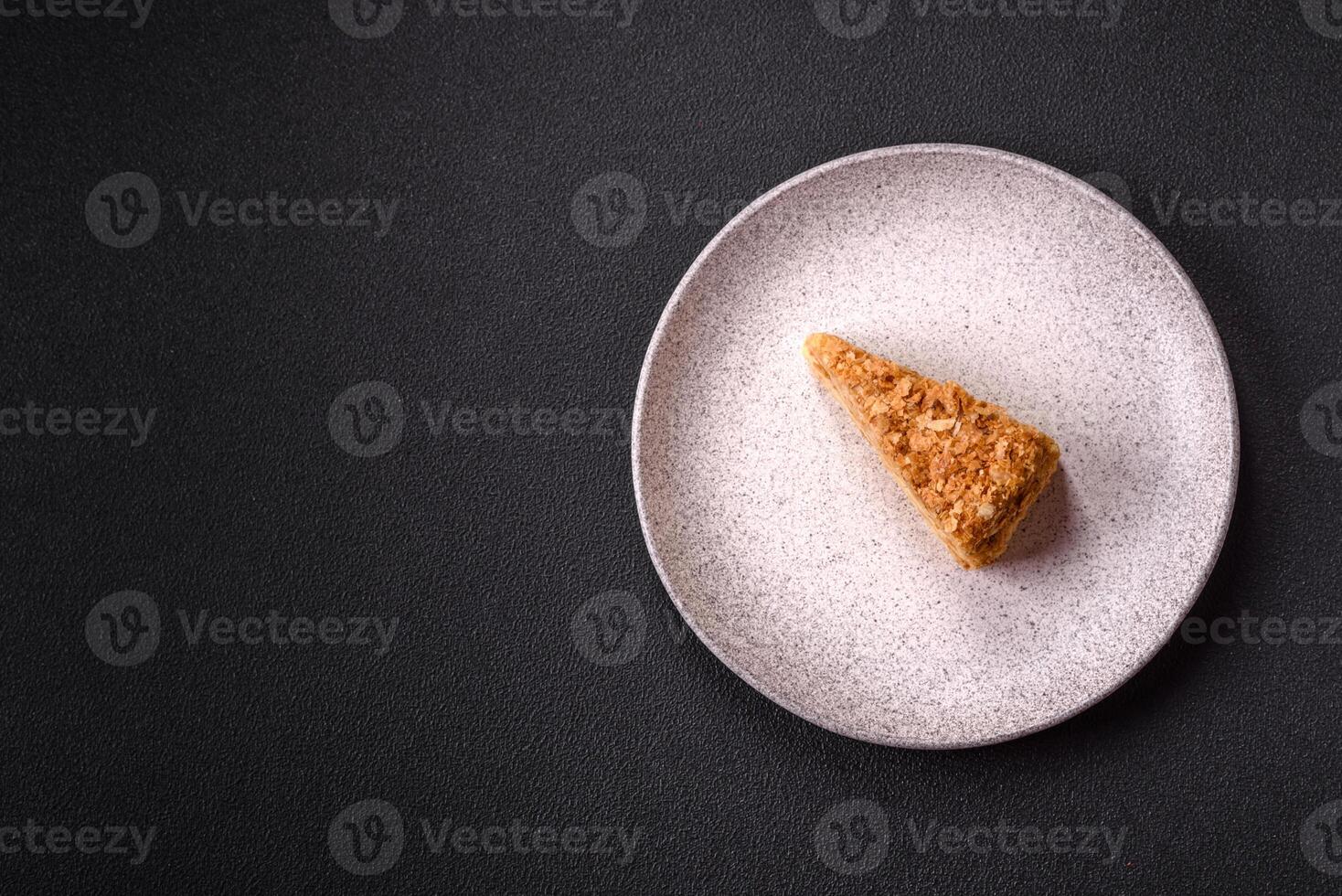 Piece of sweet layer cake Napoleon with custard photo