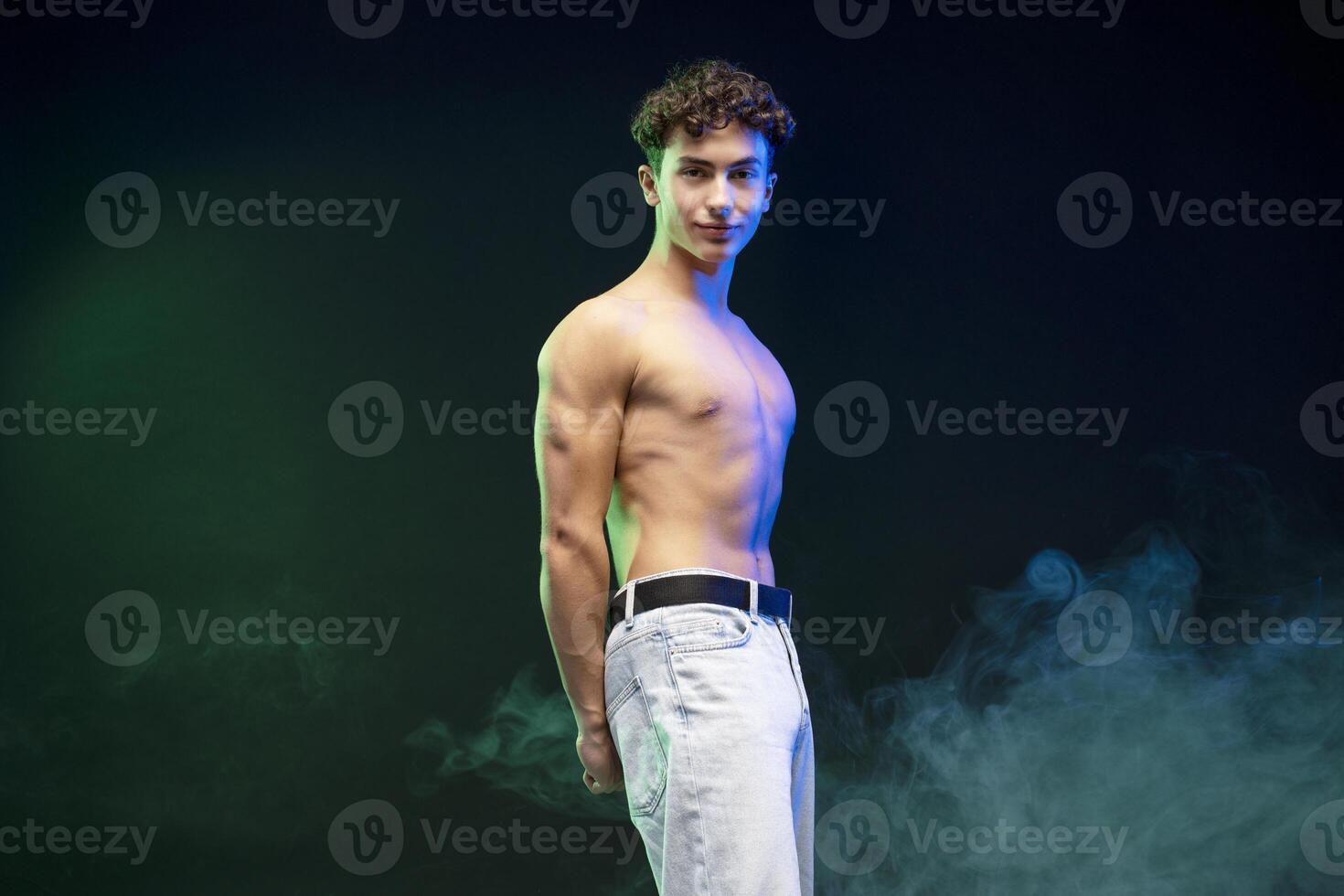 Portrait of smiling, happy teen boy, sportsman with bare torso looking at camera posing photo