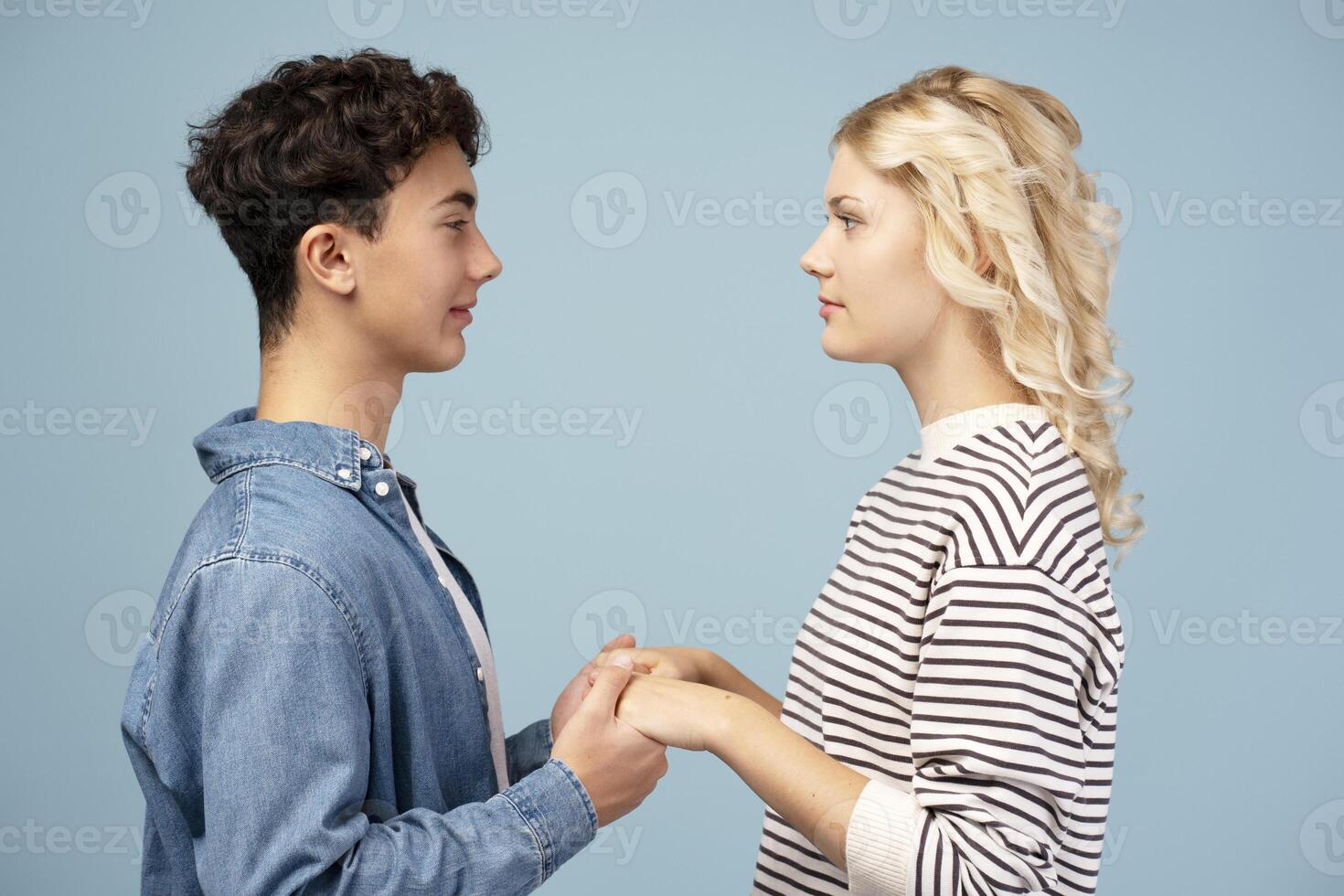 Portrait of smiling, happy couple, girlfriend and boyfriend holding hands each other photo
