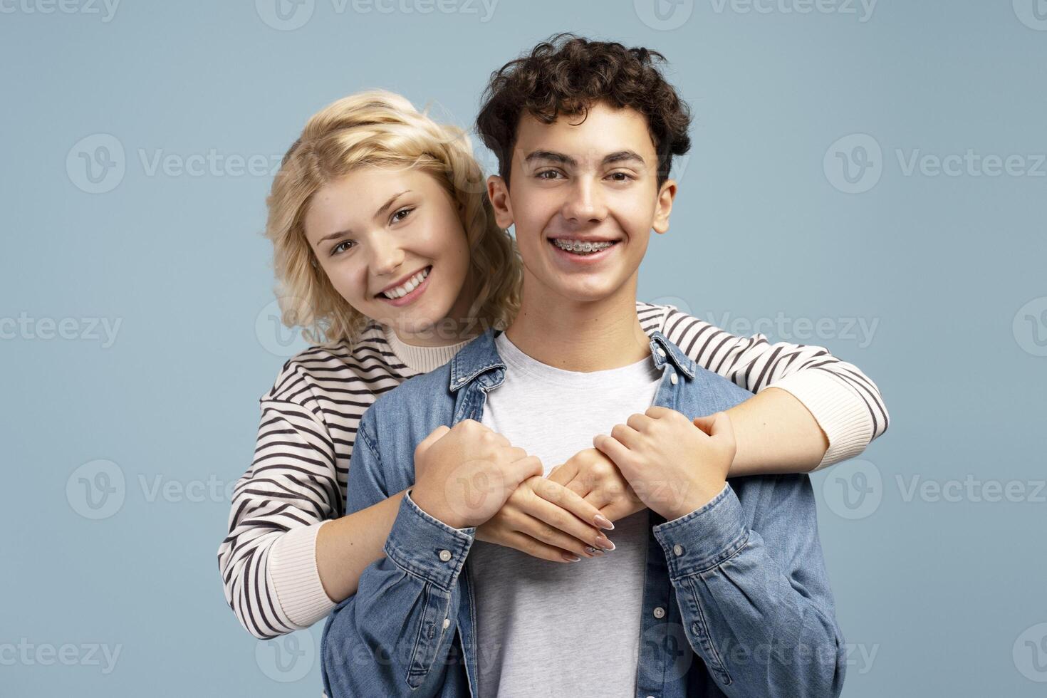 Portrait of happy, smiling young couple, boyfriend and girlfriend embracing together photo