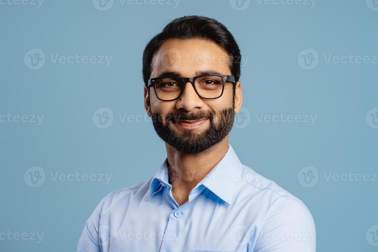 Handsome, successful Indian man, businessman wearing stylish eyeglasses, looking at camera photo