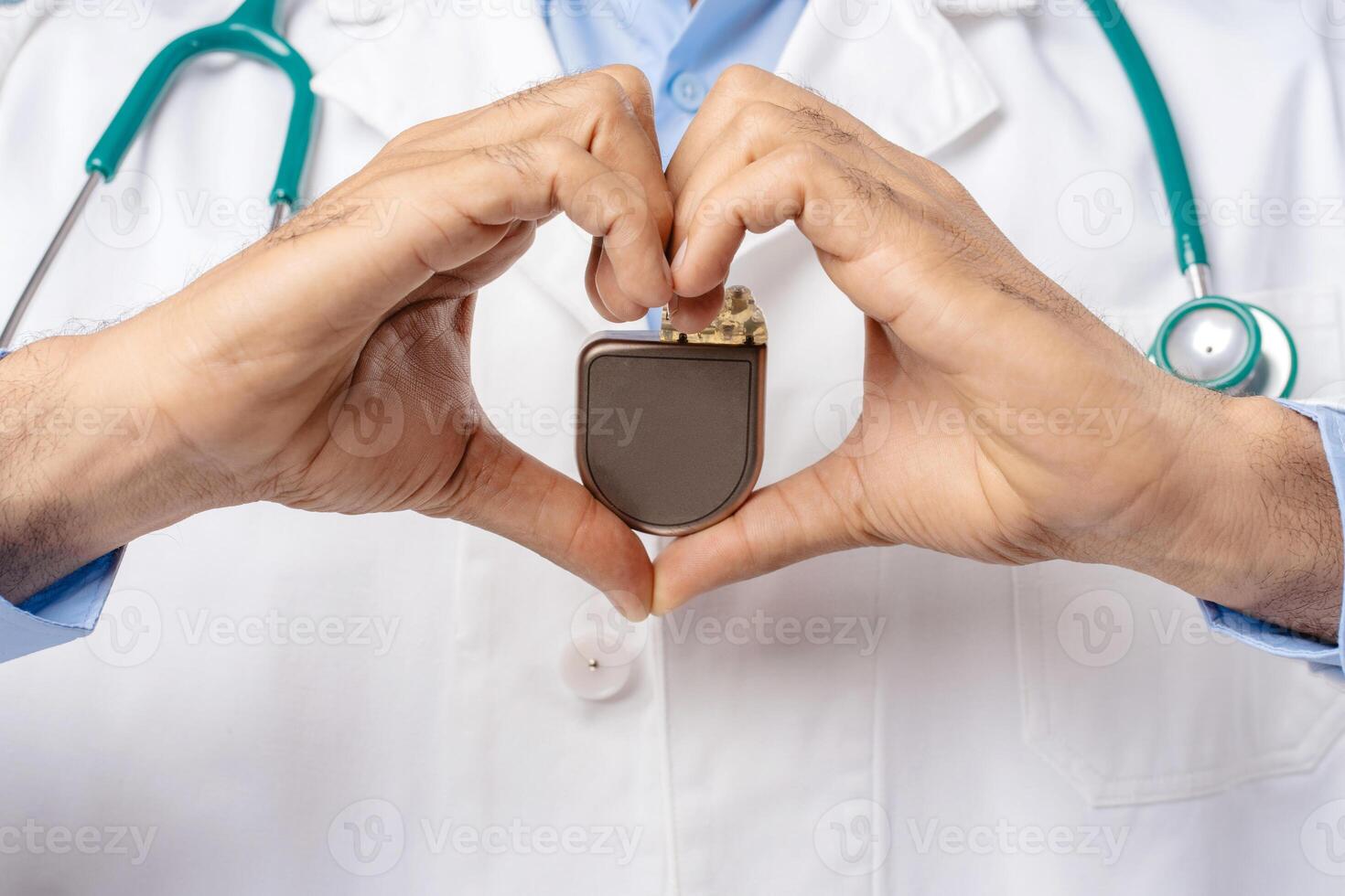 Professional doctor holding pacemaker, selective focus on hands, closeup. Cardiology concept photo