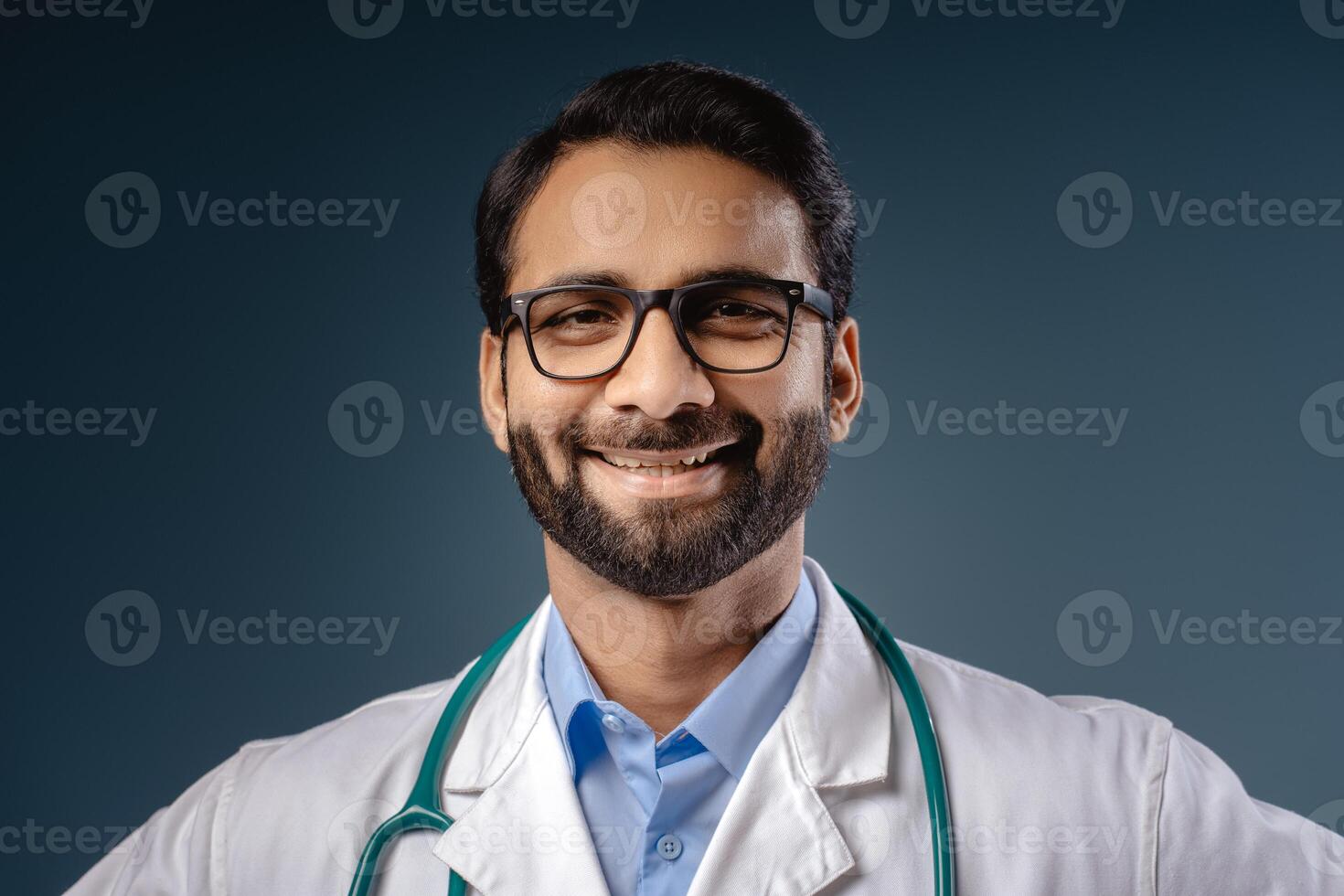 Closeup, portrait of smiling, happy Indian man wearing stylish eyeglasses, white coat photo