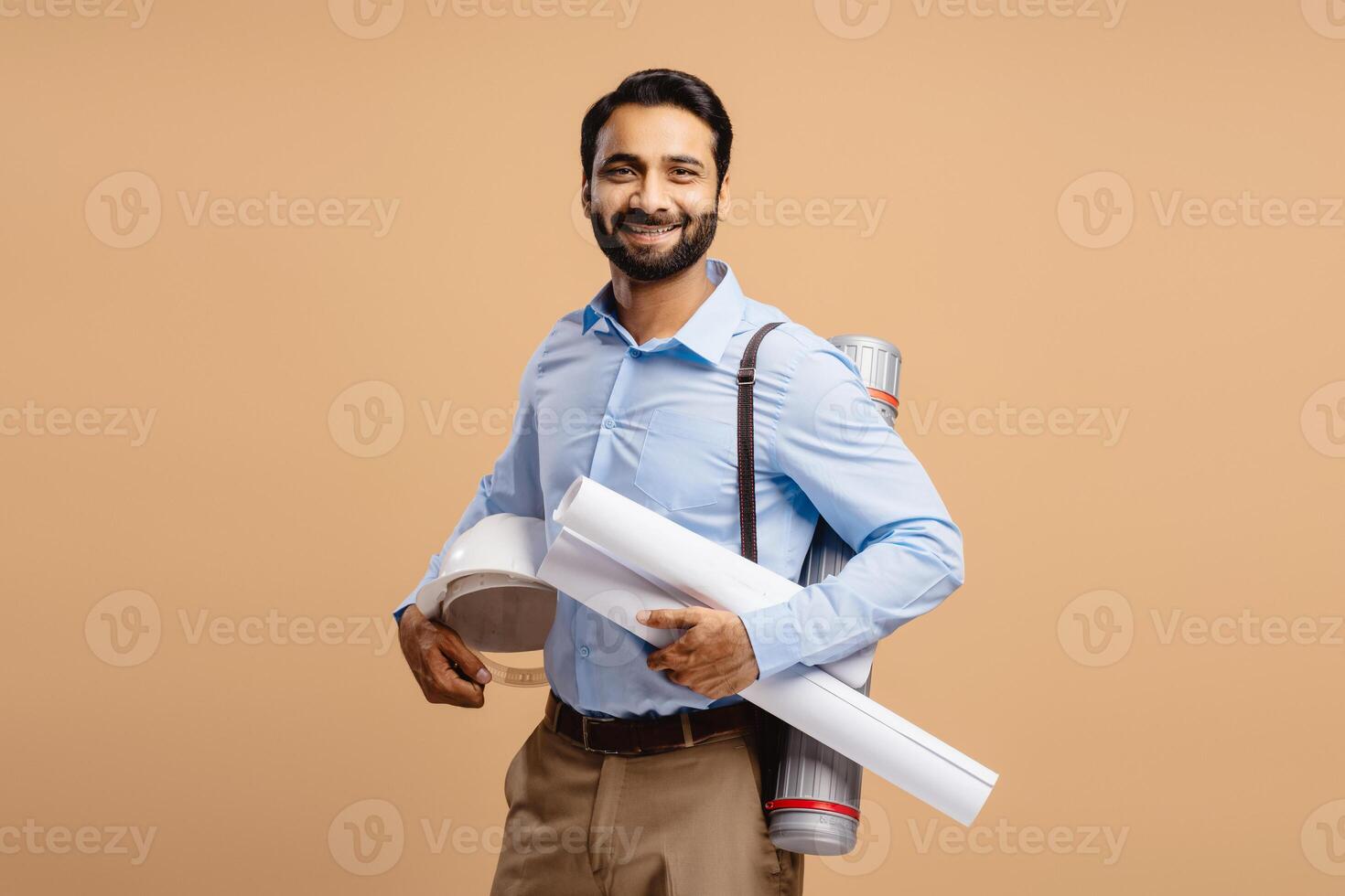 Portrait of smiling, successful middle aged businessman holding drawing and protective helmet photo