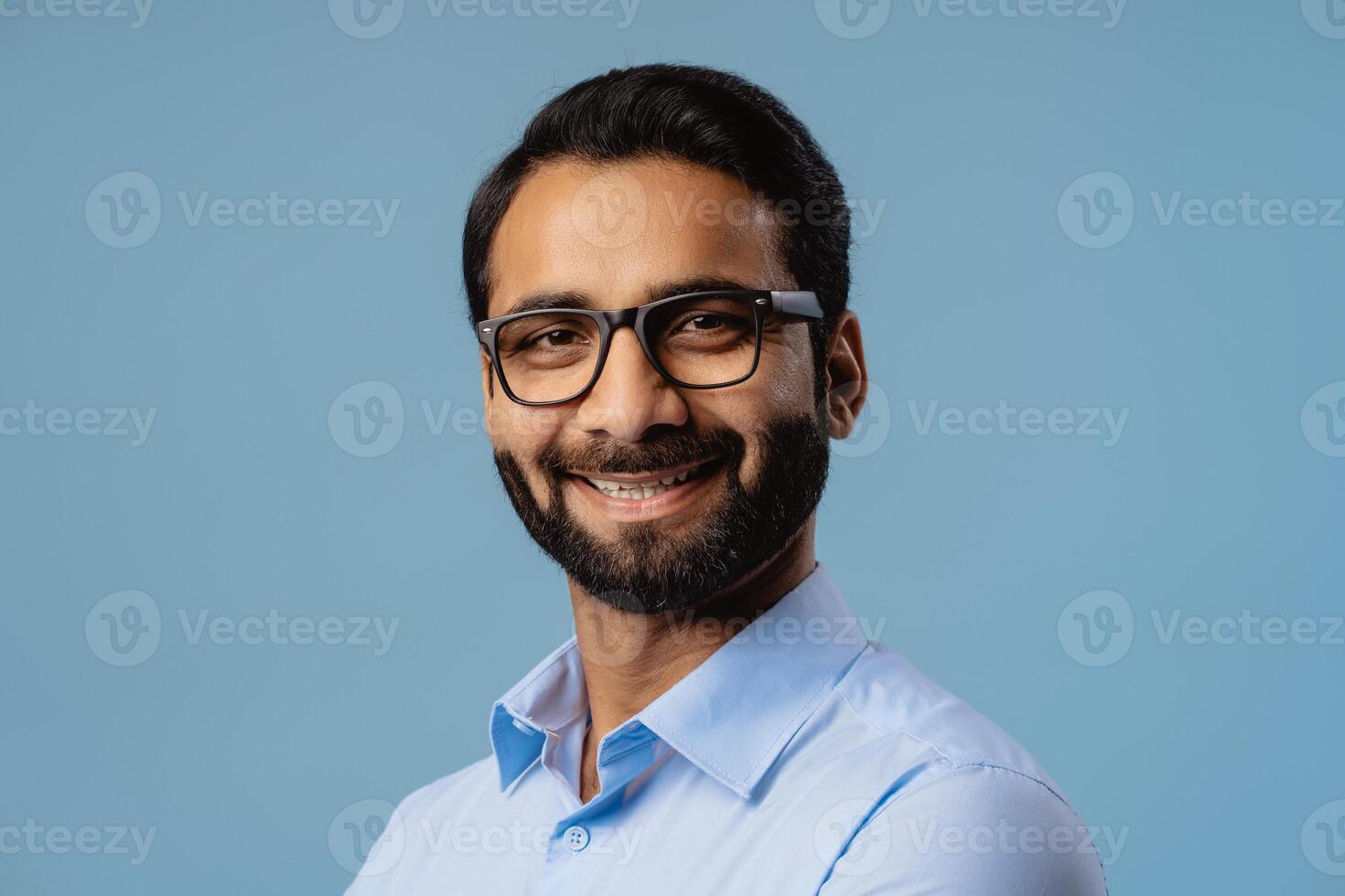 Smiling, successful Indian man, businessman wearing stylish eyeglasses, looking at camera photo