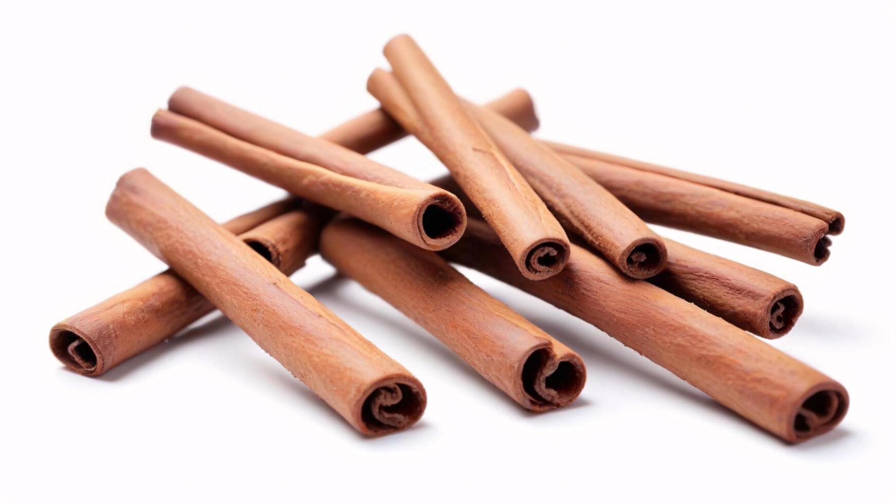Close-up of several cinnamon sticks isolated on white background. photo