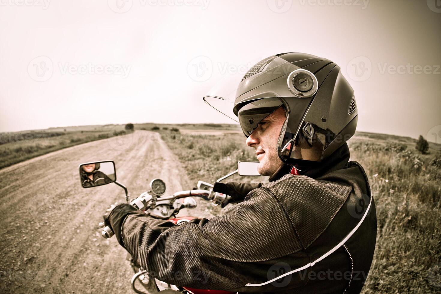 Biker on the country road photo