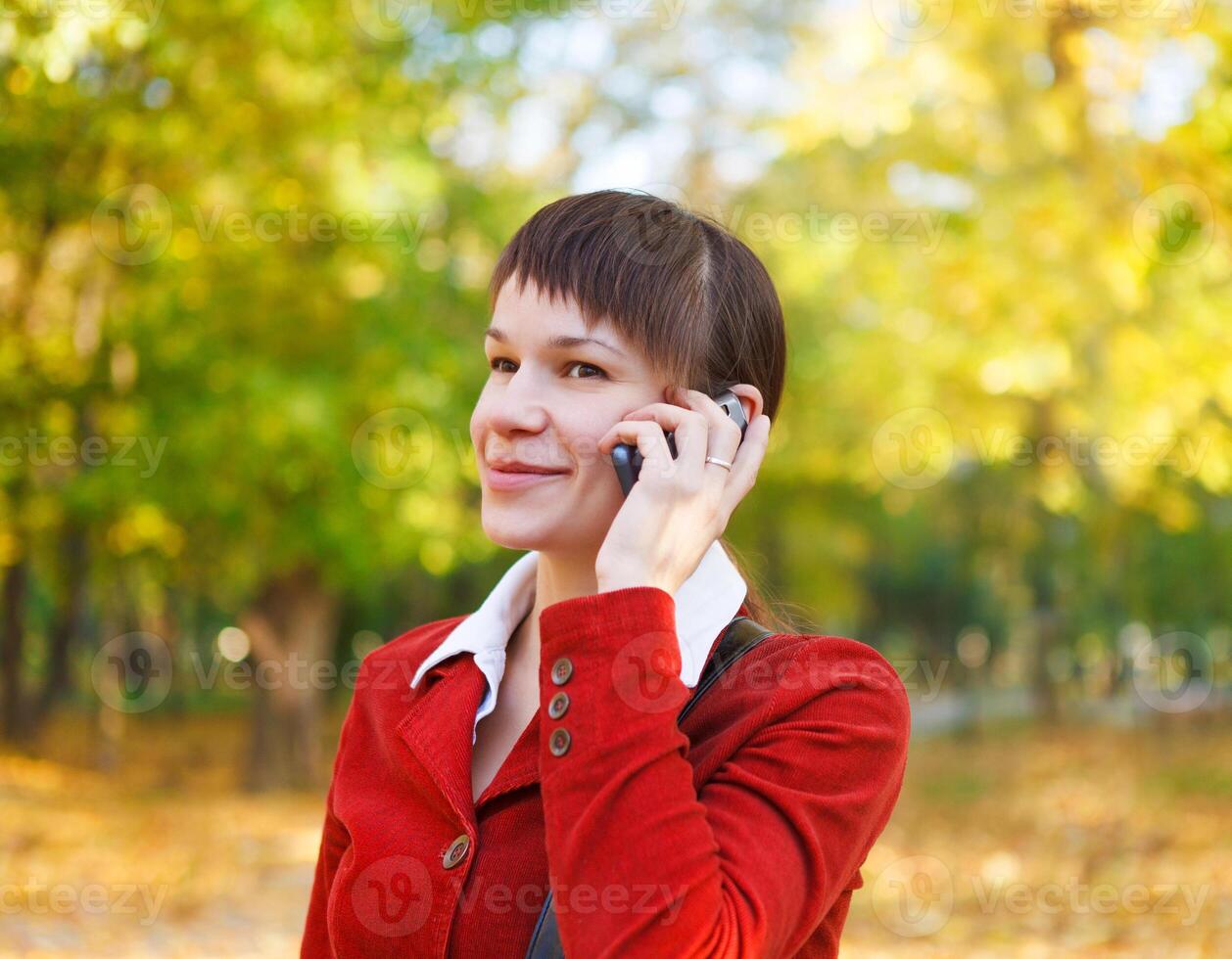 Smiling woman talking on cell phone photo