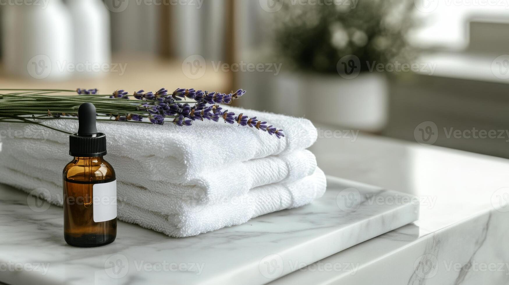 Soft white towels neatly stacked on a marble surface are accompanied by an amber glass bottle filled with lavender essential oil and fresh lavender sprigs, promoting a zero-waste lifestyle. photo