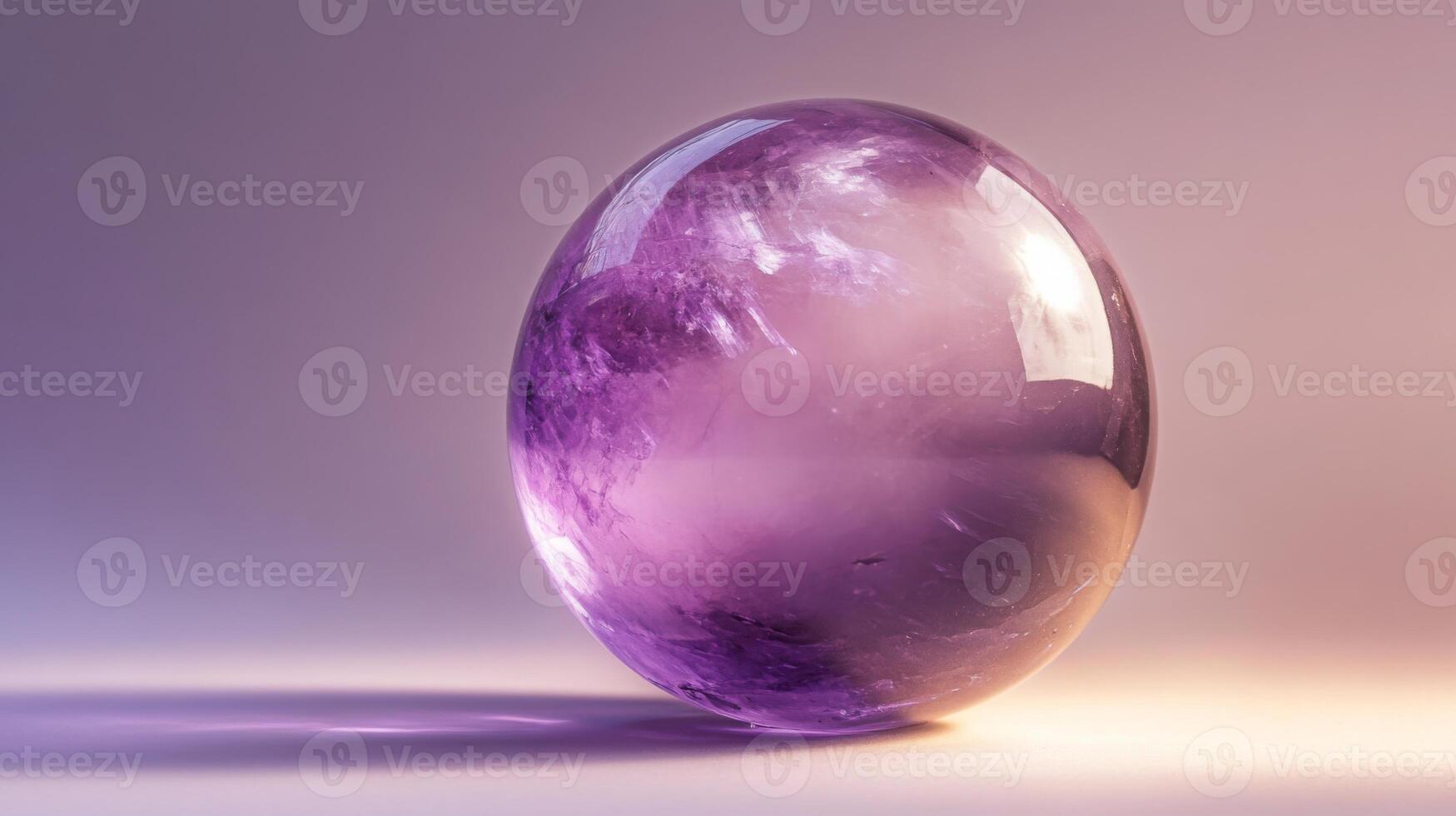 A beautifully crafted gemstone sphere displays striking purple colors, glimmering as it captures natural light. photo