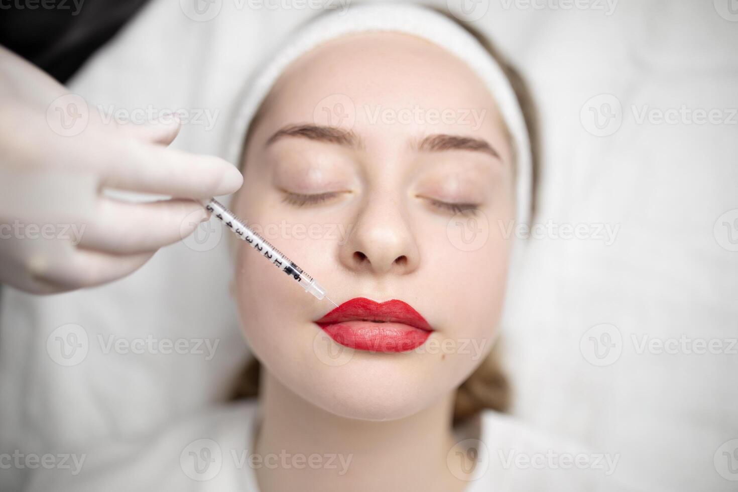 Two ladies are experiencing a pampering session in a beauty salon, undergoing a procedure for long-lasting makeup. The atmosphere is relaxing and focused on enhancing beauty. photo